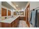 A bathroom with a dual sink vanity, tile floors and ample counter space at 12007 W 54Th Dr, Arvada, CO 80002