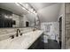 Bathroom featuring marble countertops, modern fixtures, and a walk-in shower at 12007 W 54Th Dr, Arvada, CO 80002