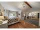 Bright bedroom featuring hardwood floors, decorative lighting, and a large window at 12007 W 54Th Dr, Arvada, CO 80002