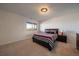 Bright bedroom featuring a comfortable bed and a scenic view from the window at 12007 W 54Th Dr, Arvada, CO 80002