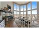 Bright dining area with a stone fireplace, large windows, and hardwood floors create an inviting and elegant space at 12007 W 54Th Dr, Arvada, CO 80002