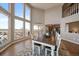 Bright dining area with a stone fireplace, large windows and hardwood floors create an inviting and elegant space at 12007 W 54Th Dr, Arvada, CO 80002