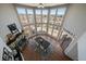 A dining room with large windows, a fireplace and a wood dining table at 12007 W 54Th Dr, Arvada, CO 80002