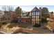 Exterior view of a two-story home, featuring a spacious deck and a beautifully landscaped yard at 12007 W 54Th Dr, Arvada, CO 80002