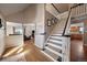 Welcoming home foyer featuring staircase, hardwood floors and views into the living room at 12007 W 54Th Dr, Arvada, CO 80002