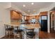 A kitchen showcasing granite counters, wood cabinets, and a breakfast bar with seating at 12007 W 54Th Dr, Arvada, CO 80002