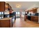 Well-lit kitchen with wood cabinets, granite countertops, and stainless steel appliances at 12007 W 54Th Dr, Arvada, CO 80002