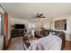 Comfortable living room featuring hardwood floors, ceiling fan, and expansive layout at 12007 W 54Th Dr, Arvada, CO 80002