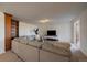 Cozy living room with a large sectional sofa and a built-in bookshelf at 12007 W 54Th Dr, Arvada, CO 80002