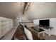 Living room featuring a brown leather sofa and a large TV at 12007 W 54Th Dr, Arvada, CO 80002