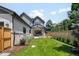A backyard with healthy green grass, a modern home, and a wood fence offers a private outdoor space at 2237 S Madison St, Denver, CO 80210