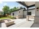 A backyard patio has a fire pit, exposed rafter coverage, and brick pillars with a view of the yard at 2237 S Madison St, Denver, CO 80210