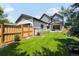 Lush backyard with green grass, wood fence, and home view provides a tranquil outdoor space at 2237 S Madison St, Denver, CO 80210