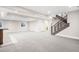 Spacious finished basement with neutral walls, plush carpet, recessed lighting, and a modern staircase at 2237 S Madison St, Denver, CO 80210