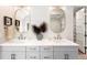 Elegant bathroom with double sink vanity, gold-framed mirrors and modern fixtures at 2237 S Madison St, Denver, CO 80210