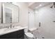 Stylish bathroom features a modern vanity, a walk-in shower, and sleek fixtures at 2237 S Madison St, Denver, CO 80210