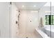 Beautiful glass shower with bench seat, rain shower head and black frame windows at 2237 S Madison St, Denver, CO 80210
