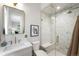 Luxurious bathroom featuring marble tile, a glass-enclosed shower, and gold fixtures at 2237 S Madison St, Denver, CO 80210