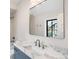 Bathroom vanity featuring stylish fixtures, a large mirror, and a beautiful stone countertop at 2237 S Madison St, Denver, CO 80210