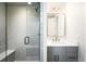 Modern bathroom with a glass-enclosed shower featuring stylish tile, a built-in bench, and a sleek vanity at 2237 S Madison St, Denver, CO 80210