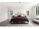 Bright bedroom featuring a modern ceiling fan, ample natural light, and two windows at 2237 S Madison St, Denver, CO 80210