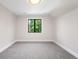 Bright bedroom featuring neutral paint, soft carpet, modern ceiling light and a window with natural light at 2237 S Madison St, Denver, CO 80210