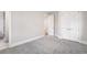 Bright bedroom featuring neutral paint, soft carpet, closet, and an open doorway leading into the ensuite at 2237 S Madison St, Denver, CO 80210