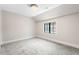 Bright, neutral bedroom with a large window, grey carpet, and white trim at 2237 S Madison St, Denver, CO 80210