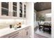Butler's pantry with a pass-through to a stylish dining area with hardwood floors and modern fixtures at 2237 S Madison St, Denver, CO 80210