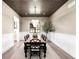 Elegant dining room featuring a modern chandelier, wood-look flooring, and a decorative plant at 2237 S Madison St, Denver, CO 80210