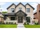 Traditional two-story brick home with a covered porch and manicured lawn, professionally landscaped at 2237 S Madison St, Denver, CO 80210