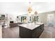 Gourmet kitchen with a large island, modern lighting, open floor plan, and backyard views at 2237 S Madison St, Denver, CO 80210