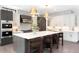 Beautiful kitchen featuring a large island, modern lighting, stainless steel appliances, and sleek cabinetry at 2237 S Madison St, Denver, CO 80210