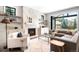 Comfortable living room with a fireplace, built-in shelving, and sliding glass doors to the backyard at 2237 S Madison St, Denver, CO 80210