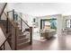 Open living room with modern stairs, marble fireplace, and sliding glass doors to the backyard at 2237 S Madison St, Denver, CO 80210