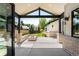 The patio features a fire pit, exposed rafters, with black trim and brick pillars in the outdoor space at 2237 S Madison St, Denver, CO 80210