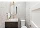 Chic powder room with modern fixtures, a decorative mirror, and stylish wallpaper at 2237 S Madison St, Denver, CO 80210