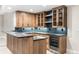 Basement wet bar with wood cabinetry, modern countertops, a stainless steel fridge, and stylish backsplash at 2237 S Madison St, Denver, CO 80210