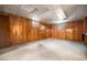 The unfinished basement offers an open layout with wood paneled walls ready for custom renovation and personalization at 6369 W 69Th Ave, Arvada, CO 80003