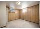 Cozy bedroom with neutral carpet and wood paneled walls, offering a serene private space in the home at 6369 W 69Th Ave, Arvada, CO 80003