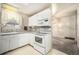 Bright and airy kitchen with sleek white cabinets, modern appliances, and a window over the sink at 6369 W 69Th Ave, Arvada, CO 80003