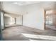 Spacious living room with a mirror accent wall and access to the kitchen and backyard at 6369 W 69Th Ave, Arvada, CO 80003