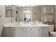 Double vanity bathroom with a large mirror and a bathtub at 3845 Canyon Ranch Rd # 104, Highlands Ranch, CO 80126