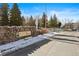 Community entrance with stone signage and flag at 3845 Canyon Ranch Rd # 104, Highlands Ranch, CO 80126