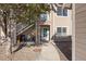 Exterior view of condo building showing walkway to entrance and landscaping at 3845 Canyon Ranch Rd # 104, Highlands Ranch, CO 80126