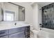 Modern bathroom with a sleek vanity, framed mirror, and tiled shower/tub combination at 1208 N Quitman St # 405, Denver, CO 80204