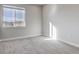 Cozy bedroom featuring a large window with natural light, plush carpet, and neutral paint at 1208 N Quitman St # 405, Denver, CO 80204