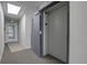 Hallway featuring an exit sign, a sturdy metal fire door, and an elevator entrance, ensuring safety and convenience at 1208 N Quitman St # 405, Denver, CO 80204