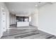 Spacious open living area with hardwood floors, recessed lighting, and a modern kitchen in the background at 1208 N Quitman St # 405, Denver, CO 80204