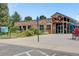 Brick recreation center featuring accessible entrances, a large parking lot, and community information signage at 4850 E Dartmouth Ave, Denver, CO 80222